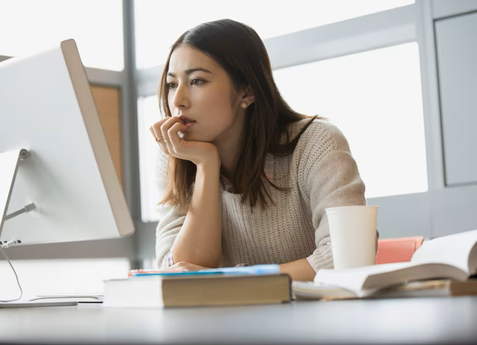 Girl at Desk looking at Computer